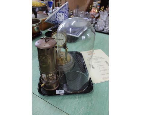 A Gustan &amp; Becker brass clock under glass dome, 13" high (not running) together with a GR6S miners safety lamp