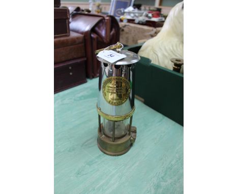 A brass and white metal miners lamp Type 6 protector lamp and Lighting Co Ltd, Made in Eccles
