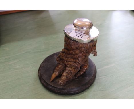 An alligator foot inkwell with white metal top and lid, stamped 'silver' (foot as found)