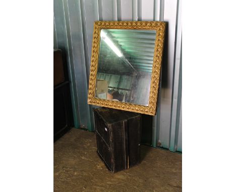 A gilt wall mirror plus a pine trunk