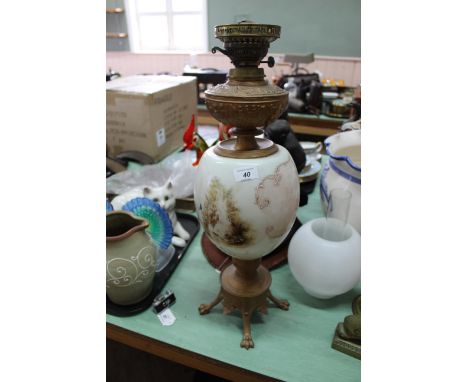 A large spelter oil lamp with globular shaped opal glass painted reservoir plus a brass oil lamp