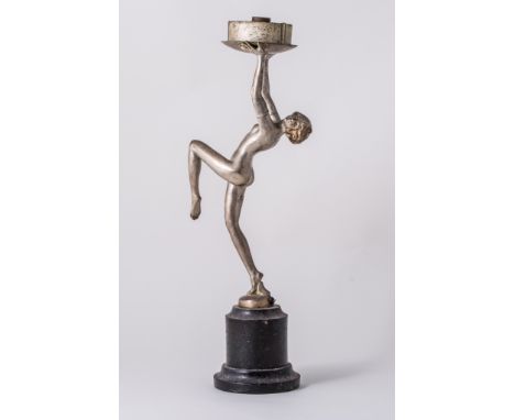 An Art Deco figural table lamp, circa 1930, in the manner of Lorenzl, modelled as a nude female poised on one leg, holding th