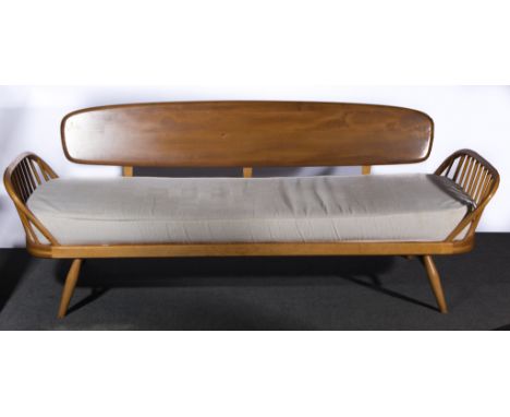 Ercol, a Studio Couch, model 355, elm and beech, three loose cushions to the back and long seat cushion, in cream upholstery,