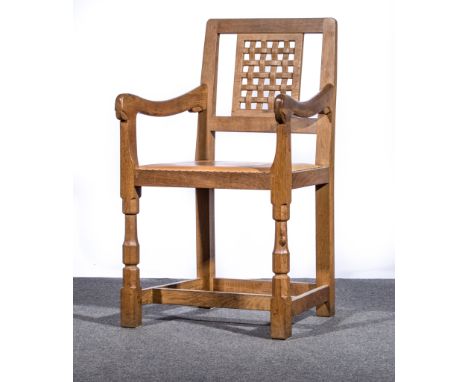 Robert 'Mouseman' Thompson of Kilburn, circa 1970, an adzed oak armchair, lattice panel back, tan leather seat, width 51cm, h