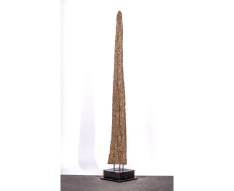 A floor standing sculpture, late 20th century, formed as a wooden trunk with natural decay, stood vertically on a square blac