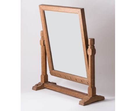 Robert 'Mouseman' Thompson of Kilburn, an oak dressing table easel mirror, with wavy top rail, on trestle support, carved sig