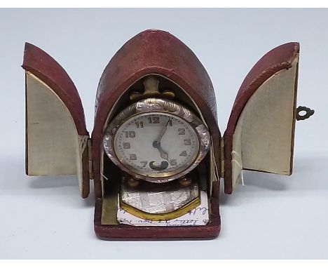 A vintage Swiss Brevet travel clock in leather case.Condition:- Genral wear through age and use, winds ok, not currently worg