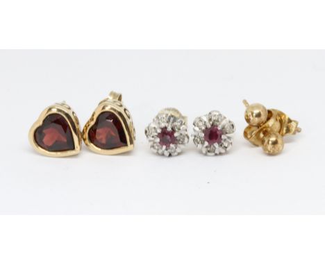 Two pairs of earrings; one diamond and ruby clusters and one heart shaped garnet, gross wt. 4.7g. 