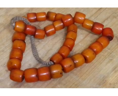 A vintage single strand of barrel shaped butterscotch bakelite beads. 