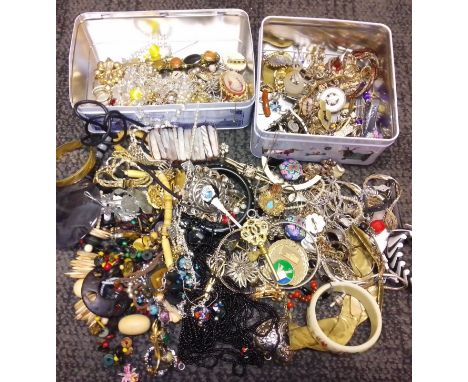 Two tins of assorted vintage and modern costume jewellery. 
