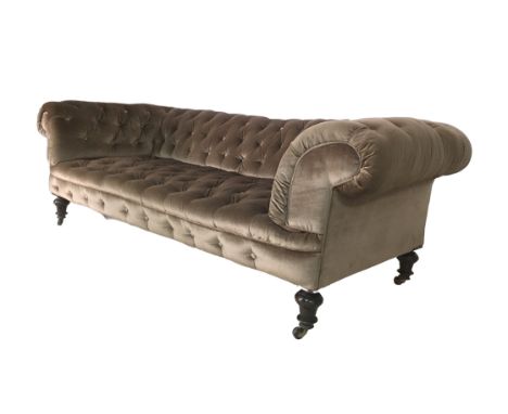 An early 20th century Chesterfield settee, with button back pale brown upholstery, raised upon turned legs with castors, 203 