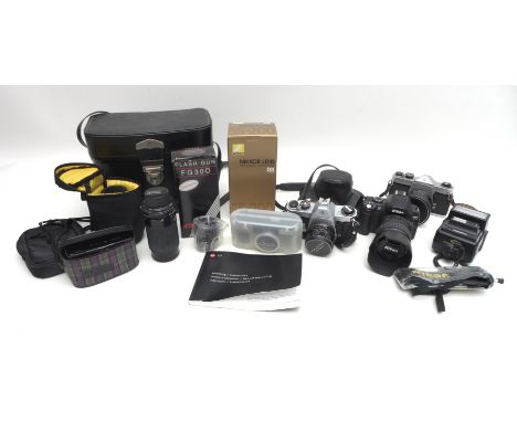 A collection of cameras and lenses, including a modern Leica C3 camera together with Praktika and Minolta cameras. (q)