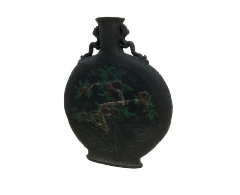 A Chinese moon flask, early 20th century, black pottery with twin dragon handles, decorated in relief on both sides, to one s