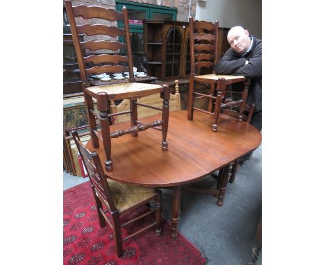 OAK EXTENDING DINING TABLE AND FOUR RUSH SEATED LADDER BACK CHAIRS 