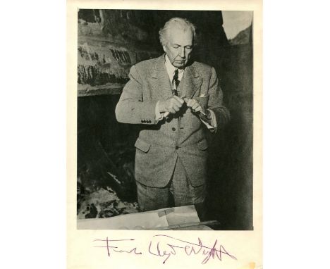 WRIGHT FRANK LLOYD: (1867-1959) American architect and designer. Vintage signed 7 x 10 photograph of Wright standing in a thr