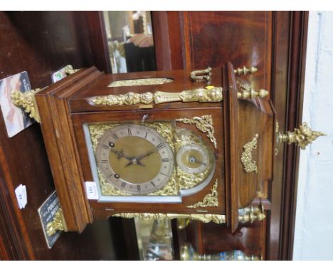 A late Victorian walnut and ormolu bracket clock, the flare finial over a caddy top above figural floral mounts and paw feet,