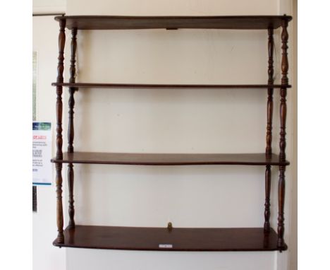 A Regency style four tier mahogany wall shelf, with ring turned baluster supports, 70cm square