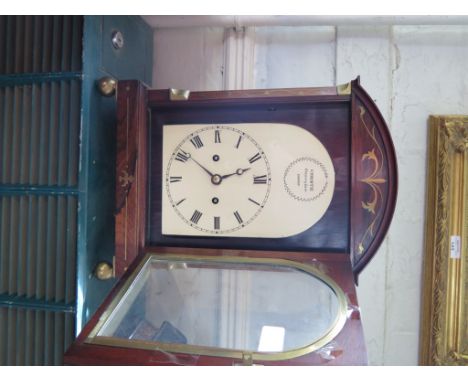 A Regency rosewood and brass inlaid bracket clock, the arched case with grape and vine ring handles, canted corners and ball 