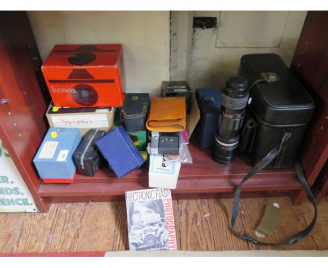 An Olympus OM20 SLR camera, a Kowa SLR camera (with box), a Zenit E SLR camera (with box), a telephoto lens and other accesso