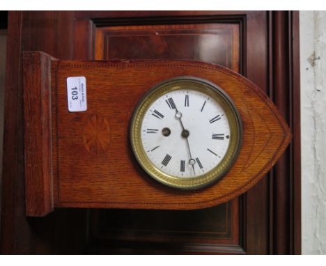 An Edwardian oak and chevron banded mantel clock, the lancet arched case with inlaid patera enclosing an enamel dial, single 