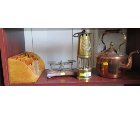 A copper kettle, brass postal scale, letter rack and miners lamp