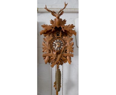 A 20th century Black Forest type carved wood cuckoo clock, 29cm high