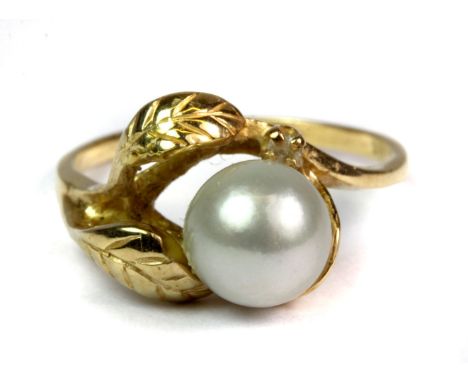 A 14ct yellow gold (stamped 14ct) leaf ring set with a  grey Tahitian pearl and a small diamond (P.5).