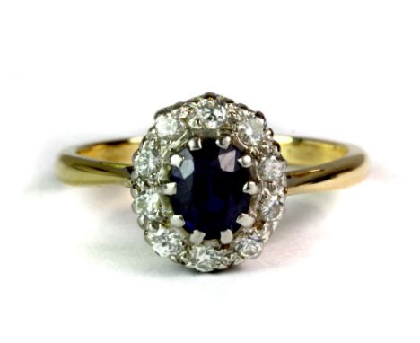 A yellow and white metal (tested 18ct gold and with a worn stamp) sapphire and diamond set cluster ring (K).