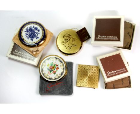 Four vintage Stratton powder compacts.