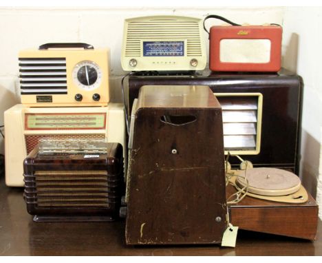Seven mixed vintage radios including one with a record player in the back.