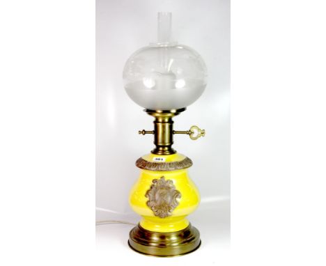 A large ceramic and brass electric table lamp in the form of an oil lamp, H. 72cm.
