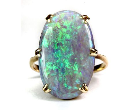 A yellow metal (tested 18ct gold) ring set with a large natural blue opal, opal size 2 x 1.8cm (J).