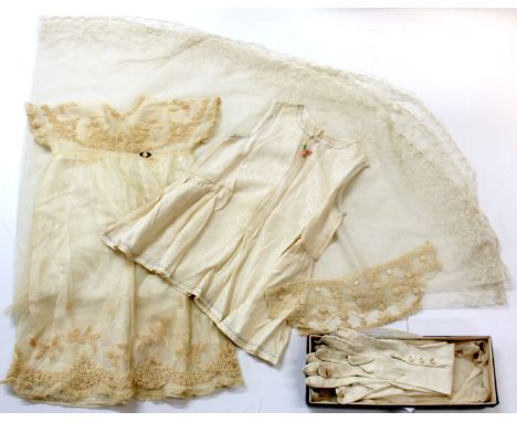 A vintage lace wedding veil, christening gown and gloves.