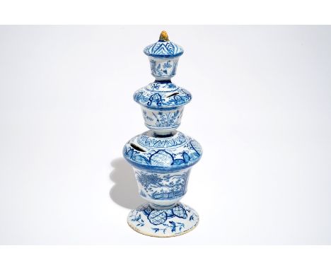 A large Dutch Delft blue and white money bank with polychrome finial, 1st half 18th C. H.: 32,5 cm We have more lots availabl