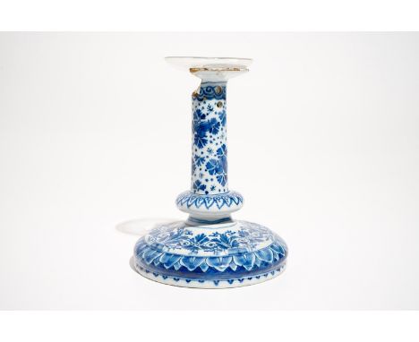 A Dutch Delft blue and white candlestick, 1st half 18th C. H.: 19 cm - Dia.: 14 cm We have more lots available for bidding on