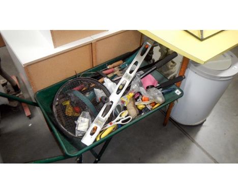 A wheelbarrow and contents of tools