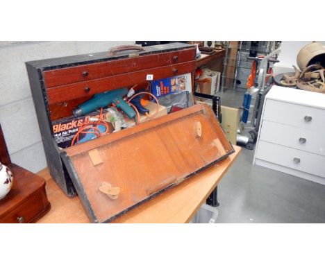 An old tool box with electric drills and other tools