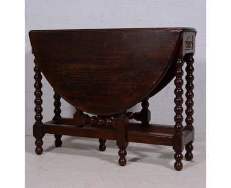 Joined oak table, oval top with fall leaves, single frieze drawer, bobbin turned gate legs, the top 90cm x 116cm, height 72cm