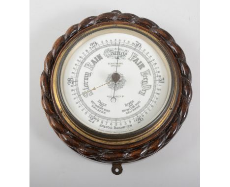 Oak cased aneroid barometer, carved frame, circular dial signed Benn Franks, Optician, diameter 24cm.