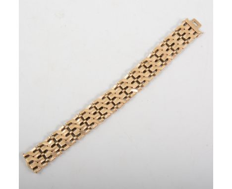 A 9 carat yellow gold bracelet, 18mm wide heavy gate design with angular plain and polished links, fitted with a tongue snap 