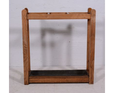 An oak and elm stick stand, three divisions, width 75cm.
