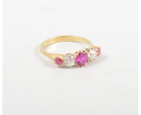 A ruby and diamond five stone ring, three rubies and two old cut diamonds claw set in a yellow and white metal mount, ring si