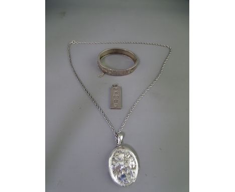 VICTORIAN &amp; LATER SILVER JEWELLERY, THREE ITEMS, including a half bright cut bangle with safety chain, an oval floral dec