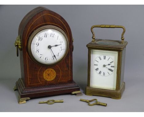 TWO VINTAGE MANTEL CLOCKS including a brass cased carriage clock having a white enamel dial set with Roman numerals before a 