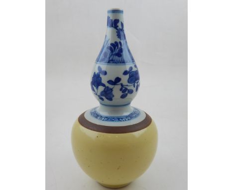 A Kangxi style blue and white double gourd vase, the lower section having yellow glaze. H: 22cm