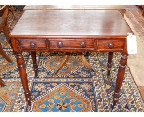 A Victorian mahogany side table, the rectangular top above an arrangement of three frieze drawers on turned tapering legs, W.