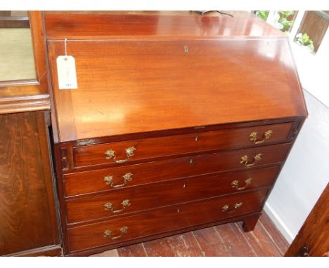 A George III mahogany bureau, the cleated fall opening to reveal  a fitted interior, above an arrangement of four long gradua