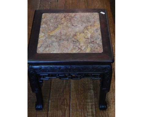 A Chinese square hardwood and marble topped side table, carved with scrolling foliage, raised on four paw feet, W. 45cm, H. 7