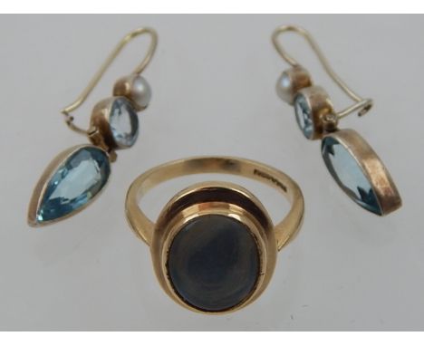 A 9 carat yellow gold and pale opal ring, together with a pair of white metal and blue topaz drop earrings. (2)