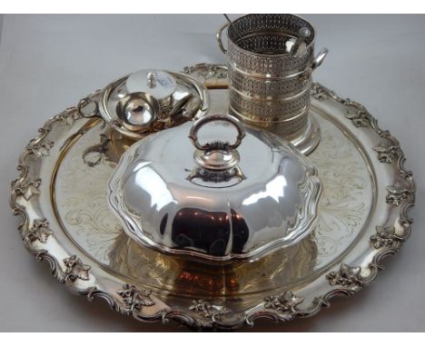 A silver plated salver with applied scroll and leaf border on four scroll feet, a circular vegetable dish with domed pull-off